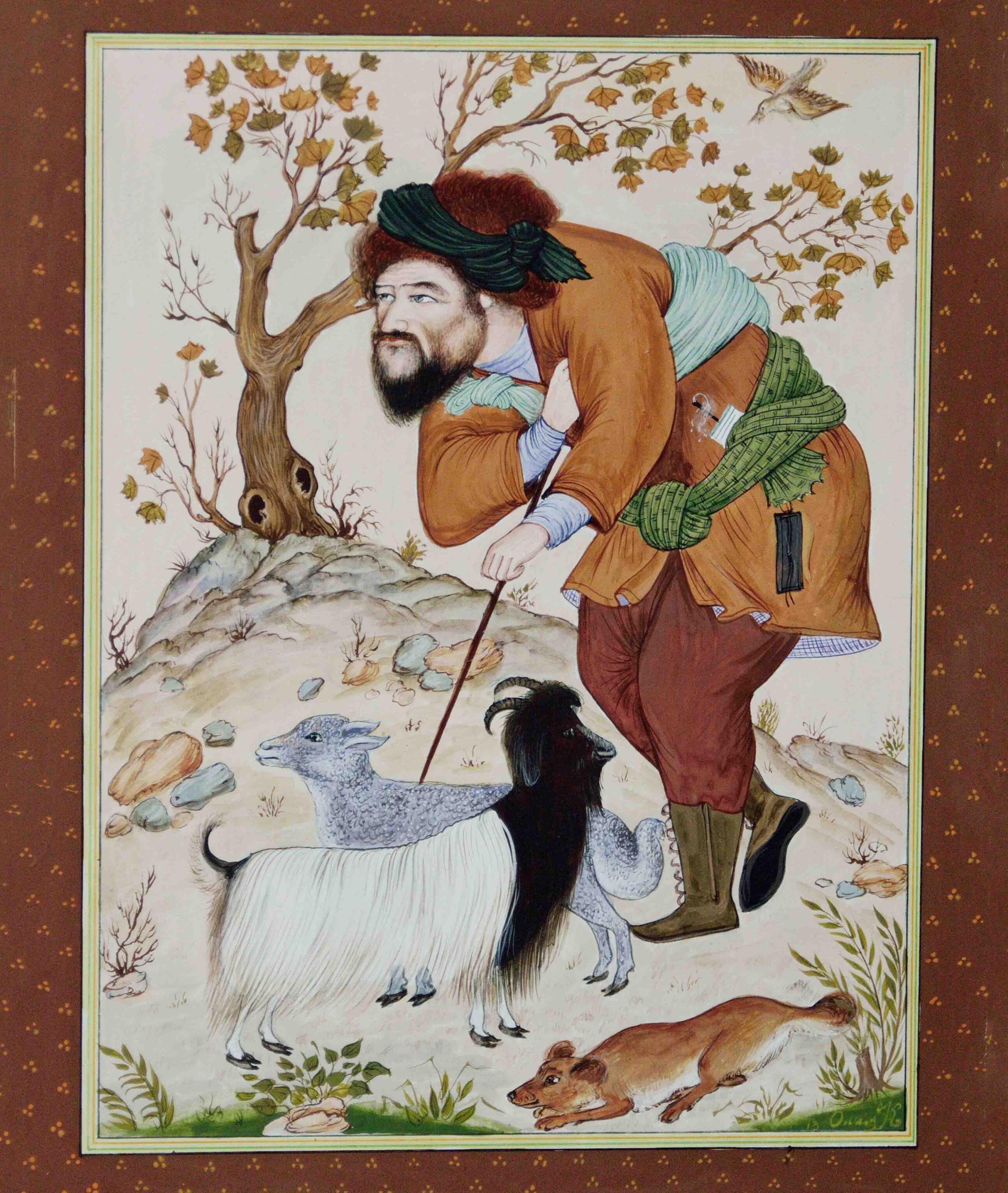 Photo of Olim Kamolzoda sitting at the desk in his workshop. He is the Honoured Artist of the Republic of Tajikistan, a Member of the Union of Artists of the Republic of Tajikistan, and a Specialist of the Miniature Art. Studying the specifics of the work